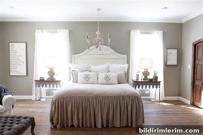 A white wooden headboard that has a gentle curve upward in the middle.