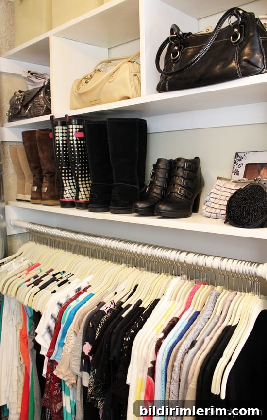 Shelves above hanging clothes used for purses