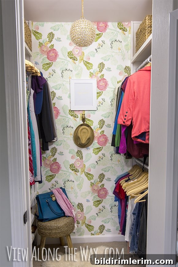 Pretty pink closet with wallpaper and two hanging rods