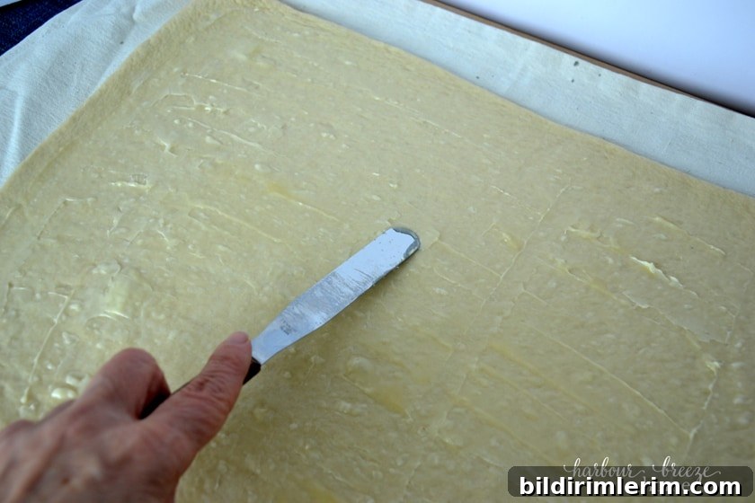 Spread butter on dough