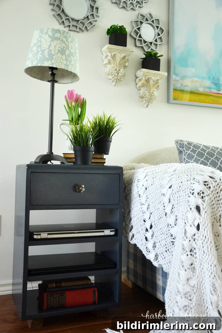 Repainted end table used as laptop stand by the couch