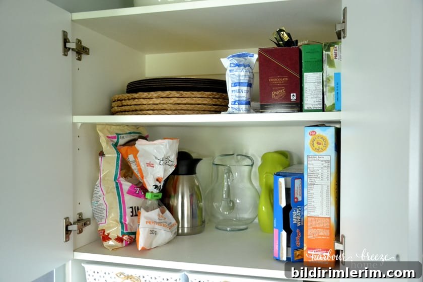 the top shelves of a cupboard pantry organized