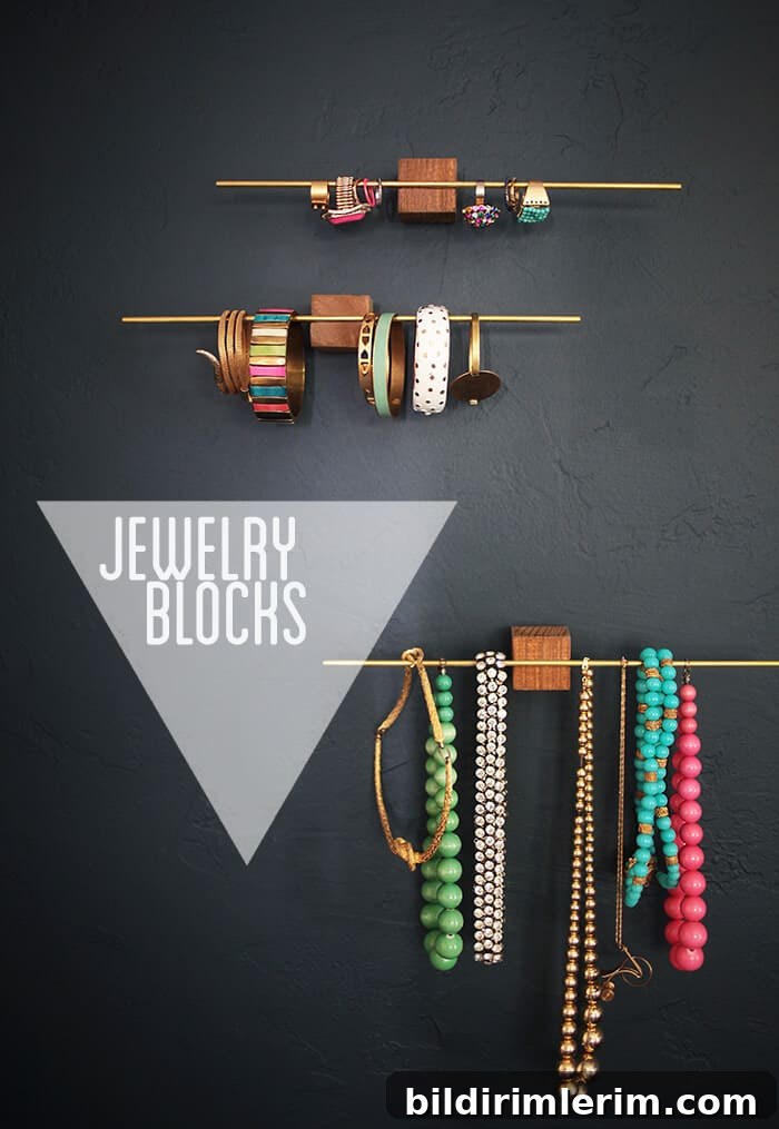 Thin metal rods adhered to wooden blocks becomes a stunning modern designed jewelry holder.