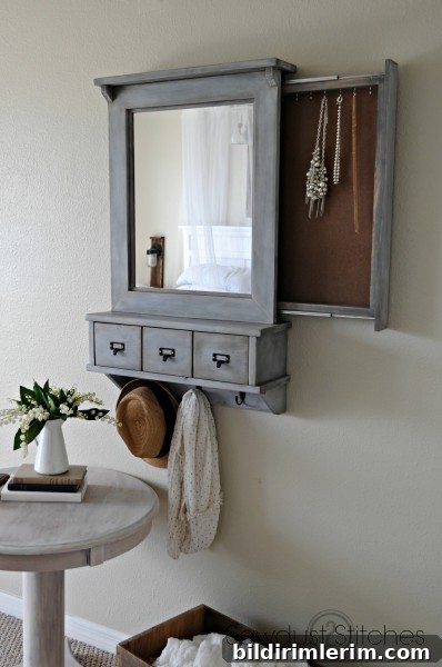 A framed mirror hides a slide out compartment that holds a jewelry collection behind.