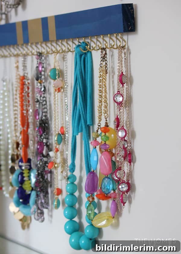 painted wooden boards with cup hooks attached on the bottom side becomes a beautiful jewelry organizer