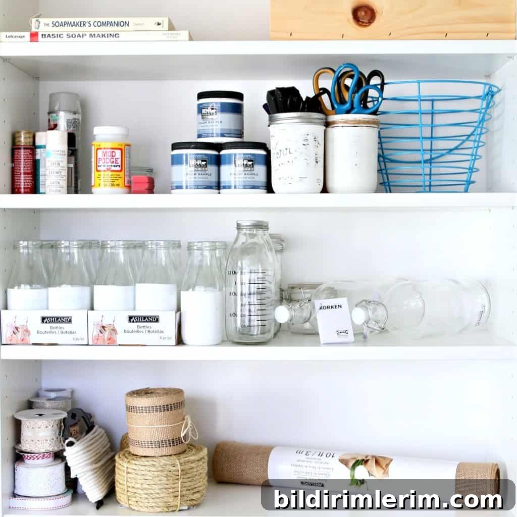 Creative and Beautiful Craft Supply Organization Ideas 8 craft paint, scissors, mod podge, ribbons, craft books, and decorative jars organized on a white bookshelf