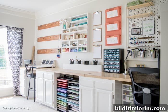 Creative and Beautiful Craft Supply Organization Ideas 9 Craft supplies like scrapbooking paper and accessories organized against one long wall with cabinets below and hanging pegboard and shelves above