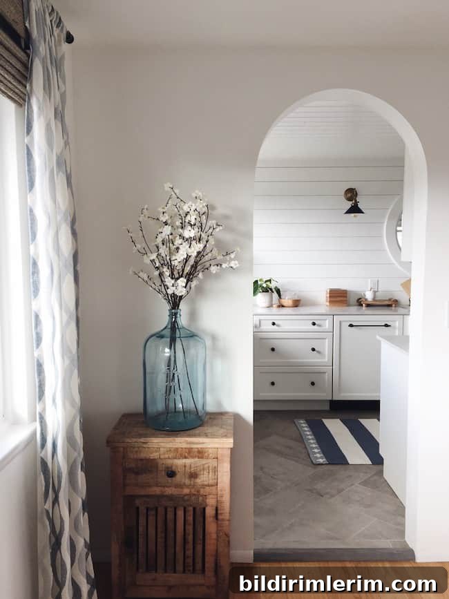 Modern Farmhouse Bloggers to Follow for Home Design 3 Archway doorway with flowers beside leading into a kitchen