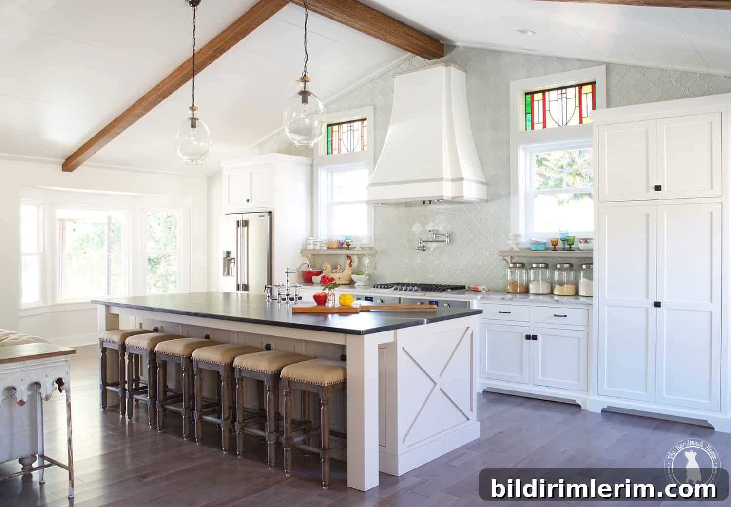 Modern Farmhouse Bloggers to Follow for Home Design 6 picture of white farmhouse kitchen with a high ceiling with wood beams