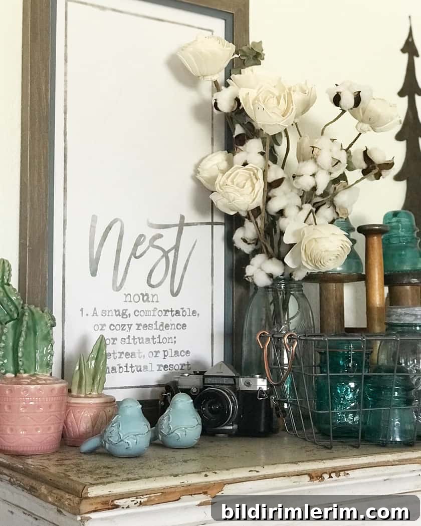 A rustic sign with a bouquet of white flowers in front of it sitting on a shelf