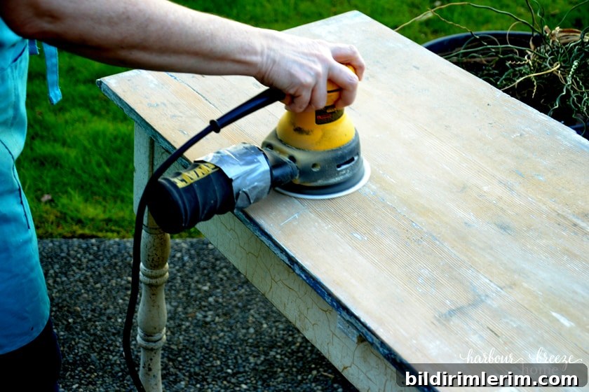 picture of a random orbital sander being used on a table top
