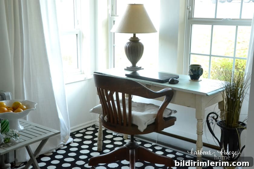 picture of desk under a bank of windows