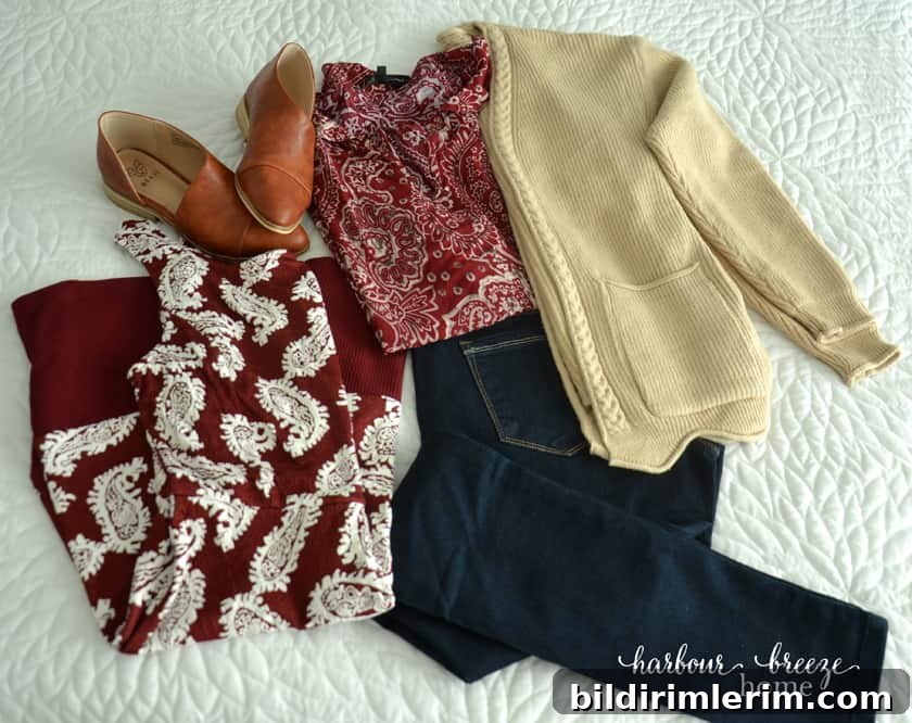 Clothes laid out on white background ~ a dress, leather flat shoes, jeans, blouse, and cardigan