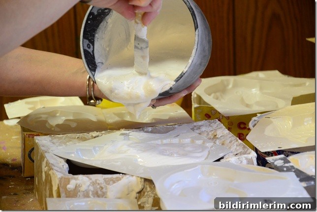 pouring plaster of paris mixture into plaster of paris moulds