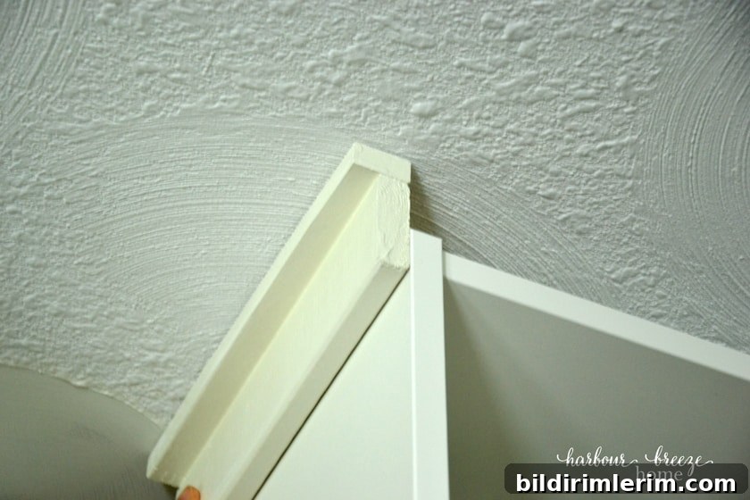 attaching side piece of molding to the billy bookcase