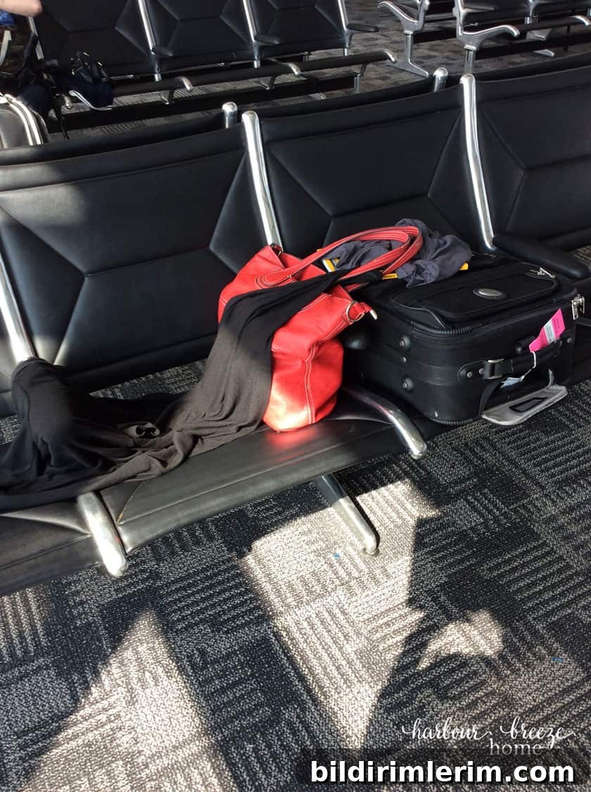 suitcase sitting on a seat in an airport