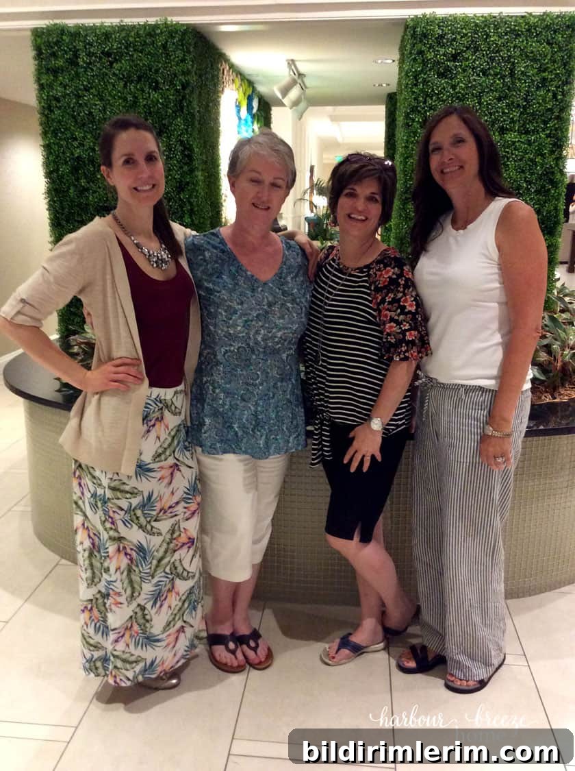 picture of 4 women in front of greenery