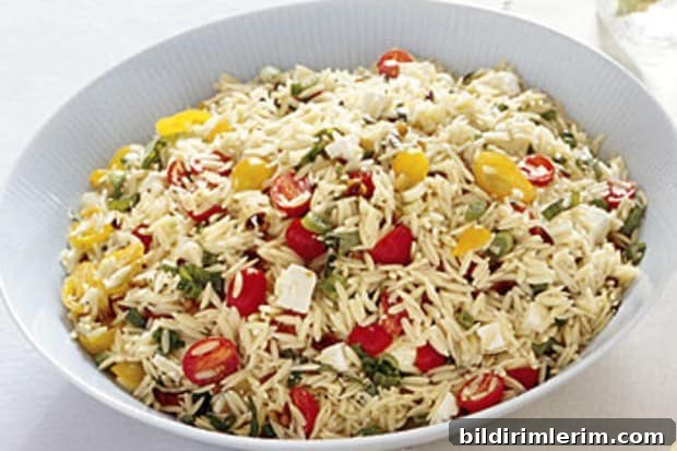 Orzo salad in a white serving bowl