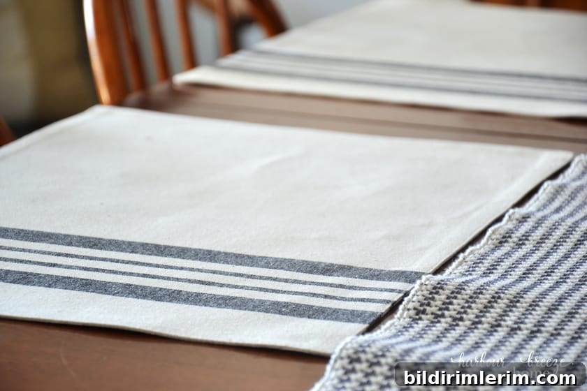close up picture of a gray striped place mat on a wooden table
