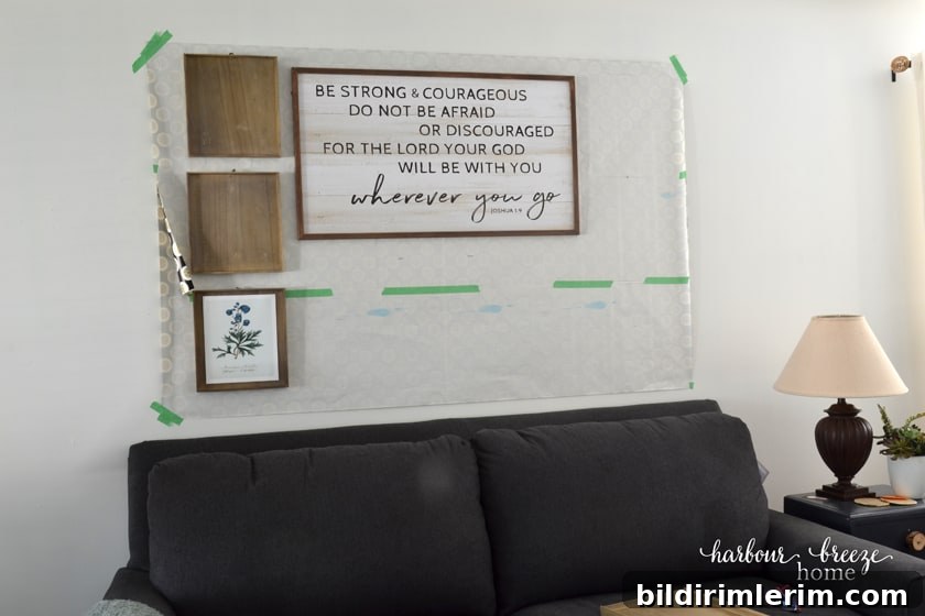 half of the pictures of a gallery wall hung on top of the gallery wall template