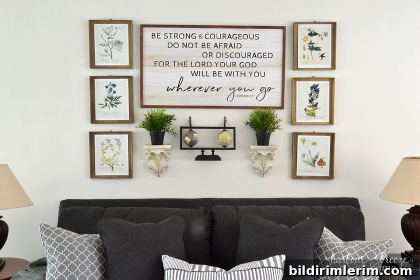 6 botanical print art prints hung around a large sign with the verse "Be strong & courageous..." to make a gallery wall arrangement above a couch