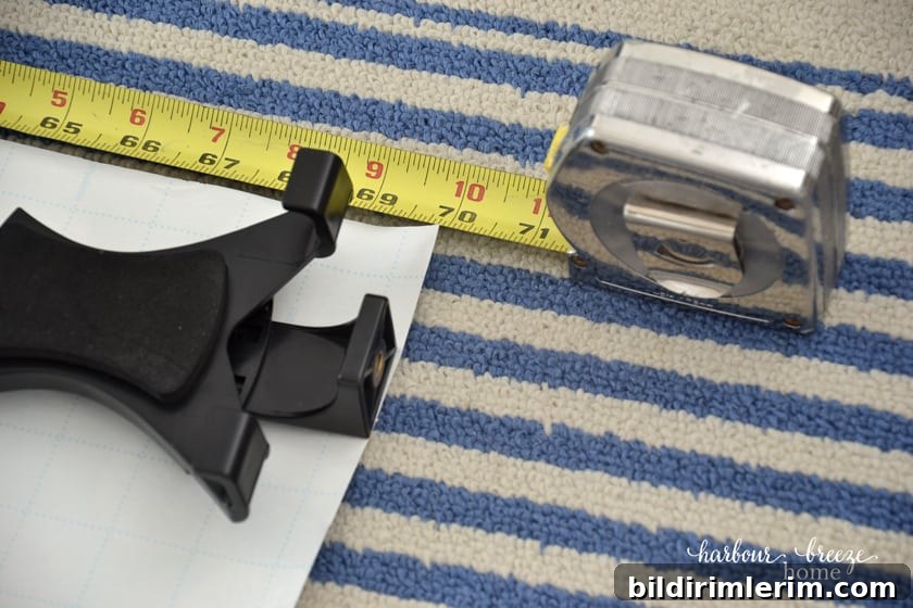 tape measure measuring a sheet of paper to make a gallery wall template
