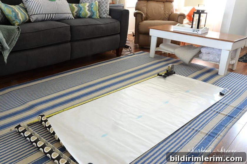 a large roll of paper laid out on the floor that will become a gallery wall template