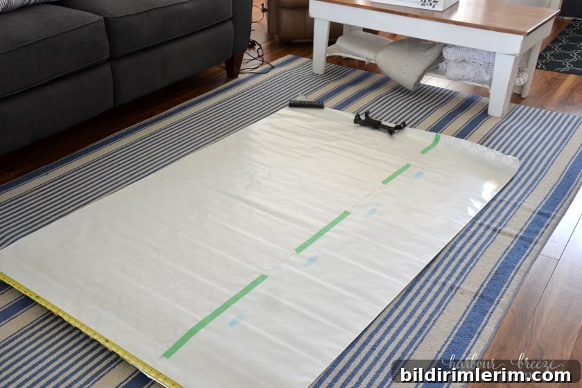 Pieces of a roll of wrapping paper taped together to make one large sheet of paper that will become a gallery wall template.
