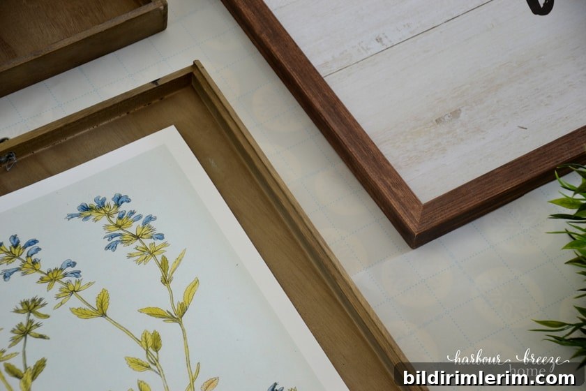 Pictures lined up on the grids of the wrapping paper gallery wall template to ensure they are straight.