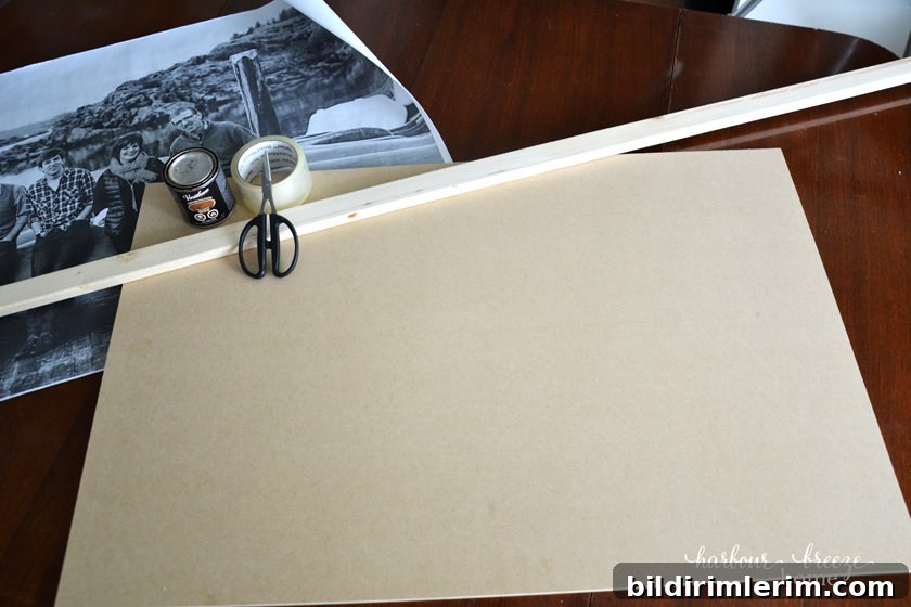 How to Frame and Engineer Print | A Budget Friendly Large Wall Art Project an engineer print, scissors, tape and wood laying on a table