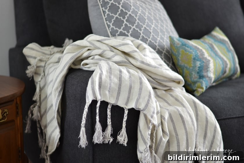 striped linen blanket draped over the arm of a couch