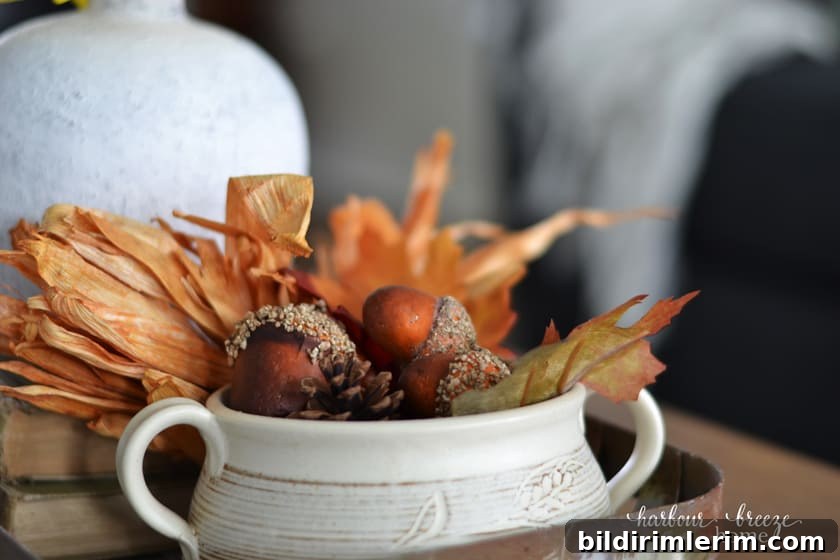pottery bowl filled with fall leaves, acorns, and pine cones
