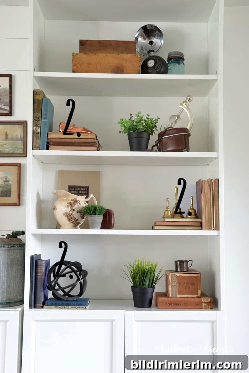 White Ikea bookcase with stacks of old books and farmhouse decor