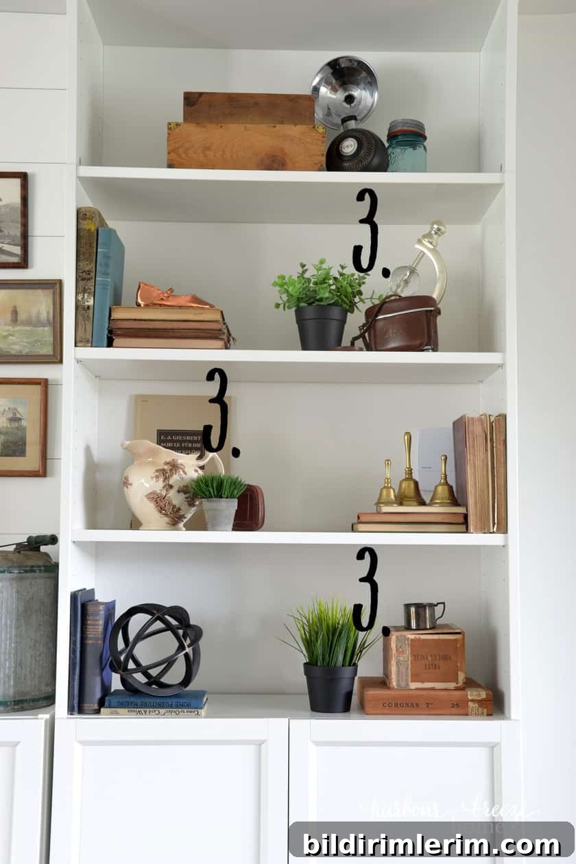 Faux greenery in a variety of pots staggered on shelves of an Ikea Billy Bookcase to add to farmhouse bookshelf decor