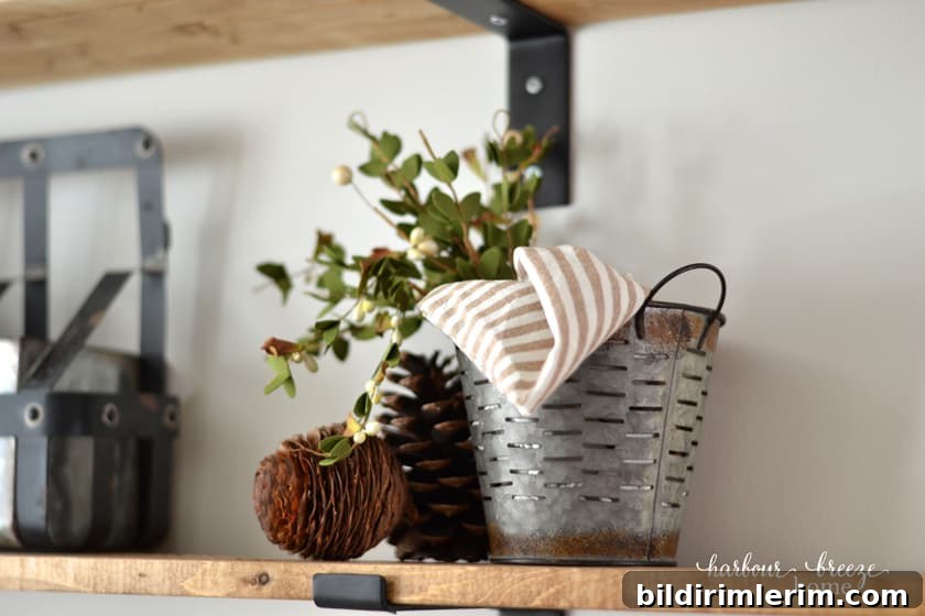 Rusty metal bucket with greenery for farmhouse styling