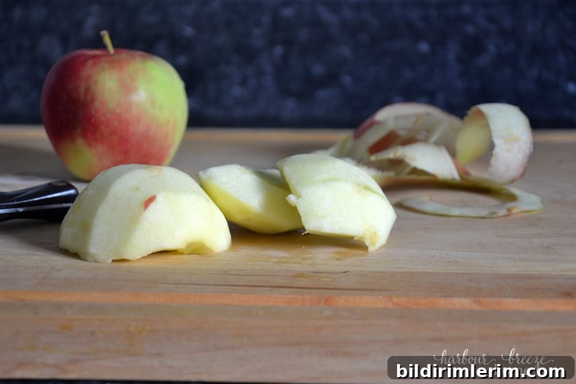 Peeled apple chunks on a cutting board