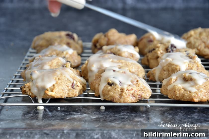 Spreading glaze onto a fresh apple cookie