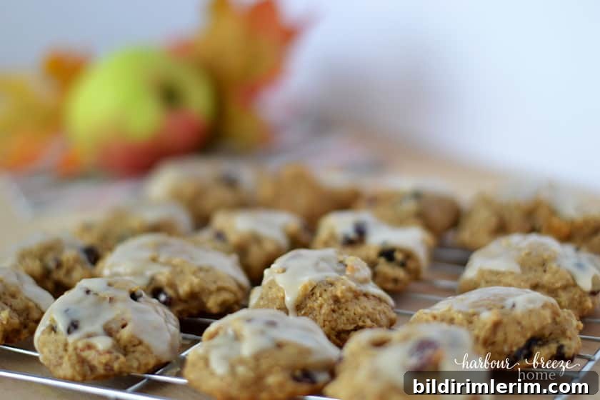 Glazed apple cookies with an apple in the background