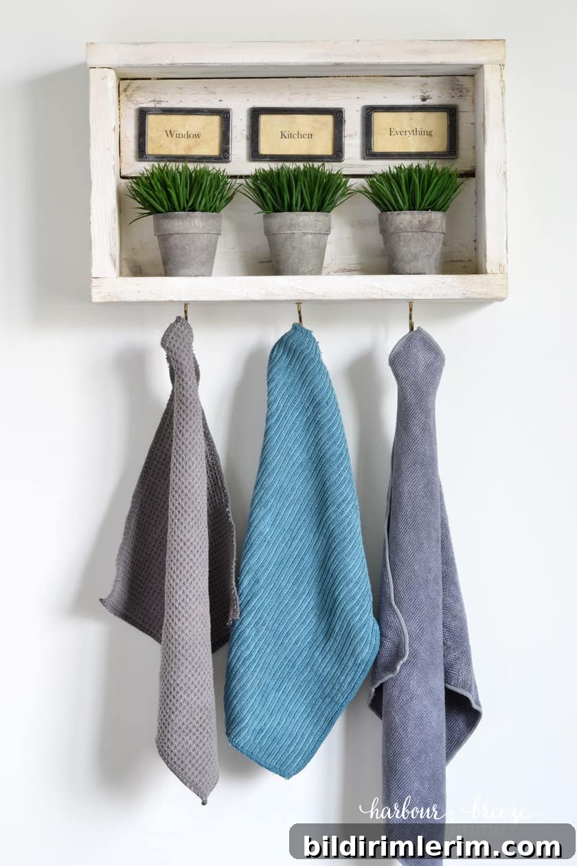 Rustic wall shelf with hooks holding Norwex cleaning cloths.