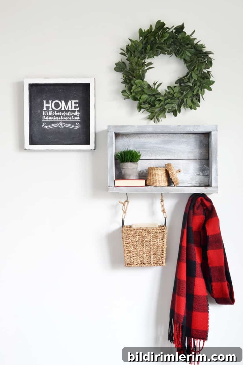 A rustic wall shelf with hooks holding a basket and winter scarf. A small basket is on the shelf with a plant beside it.