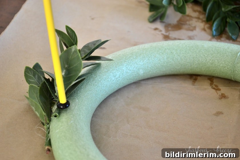 DIY Small Faux Boxwood Wreath on a Budget 4 Gluing on faux boxwood leaves to a small foam wreath form