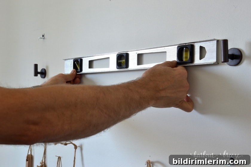 using a level to attach turnbuckle shelves to the wall