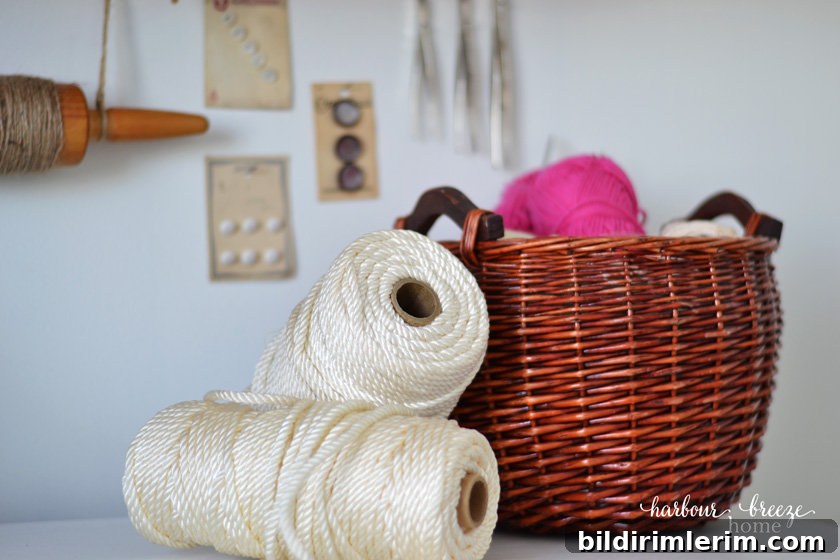 A Basket of Yarn and rolls of macrame sitting on a dresser top