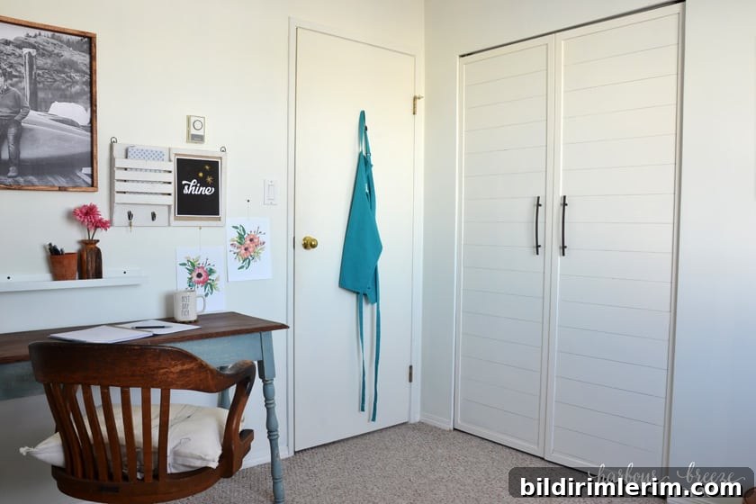 Office area with double closet doors beside it.