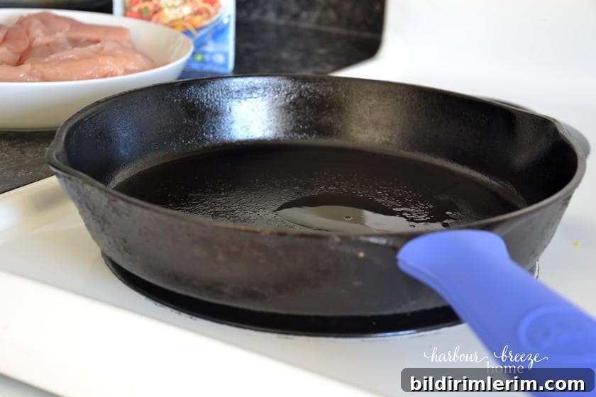 Sliced chicken pieces cooking in a pan