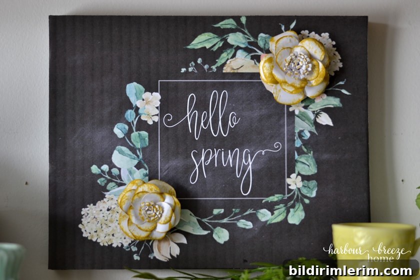 a printable flower art design on a black chalkboard background that says, "hello Spring" with flowers around the text