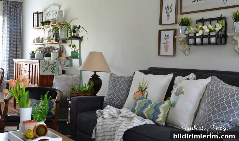 A living room after a Spring refresh has been done with fresh flowers, faux tulips, and printable plant art.