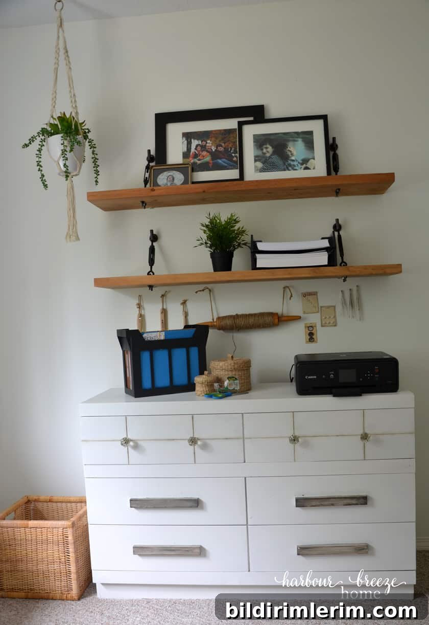 7 Clever Paper Storage Ideas to Declutter Your Home 3 A dresser with floating shelves above it with office supplies - like a printer, desktop file, and trays of printer paper sitting neatly on them.