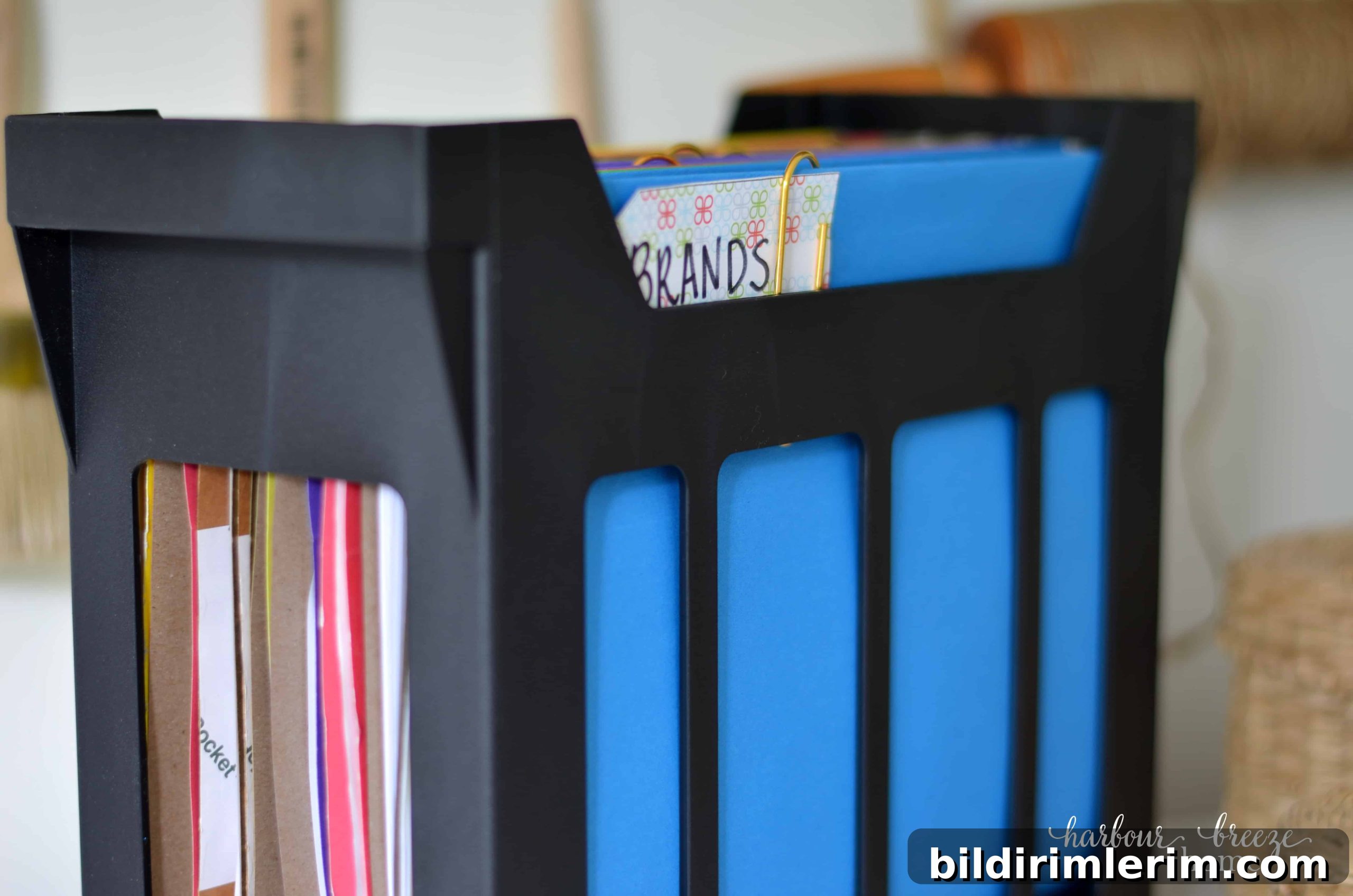 7 Clever Paper Storage Ideas to Declutter Your Home 5 A desktop hanging file folder with bright colored folders in it.