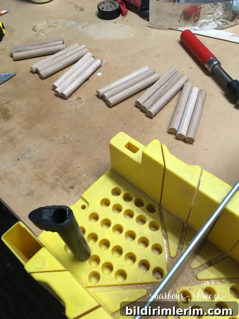 Dowels lined up and ready to be used for this DIY floating shelf with dowels.